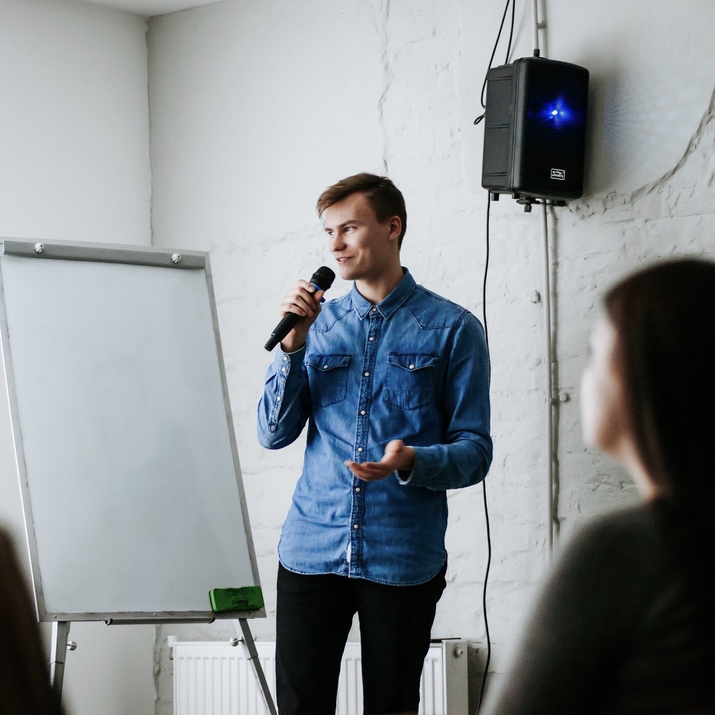 TheRoom Design Boutique CEO Nick Zaitsev speaking on the conference with a microphone